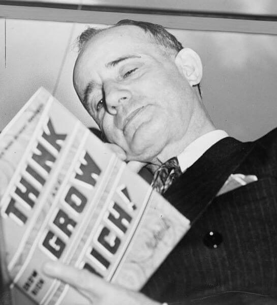 Napoleon Hill holding his book